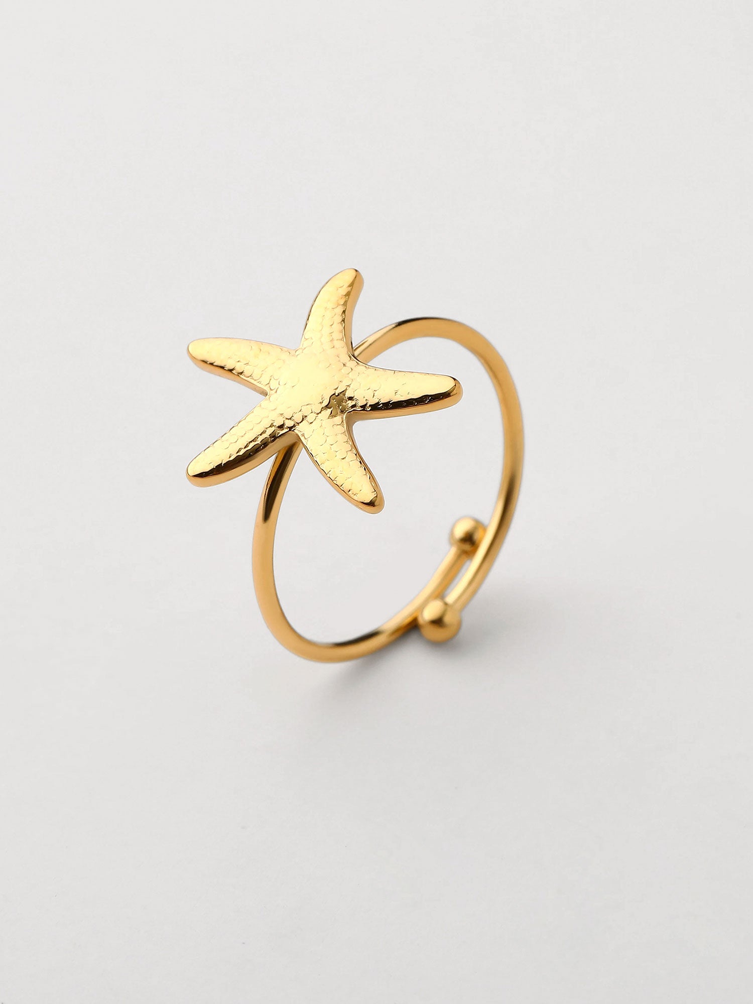 Anel com forma de estrella de mar Dourado