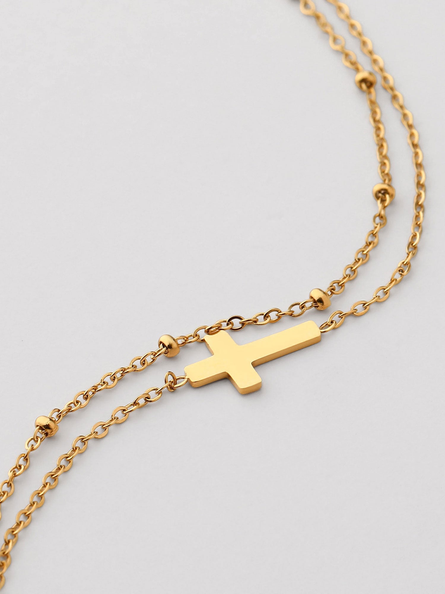 Pulseira corrente fina com cruz dorada