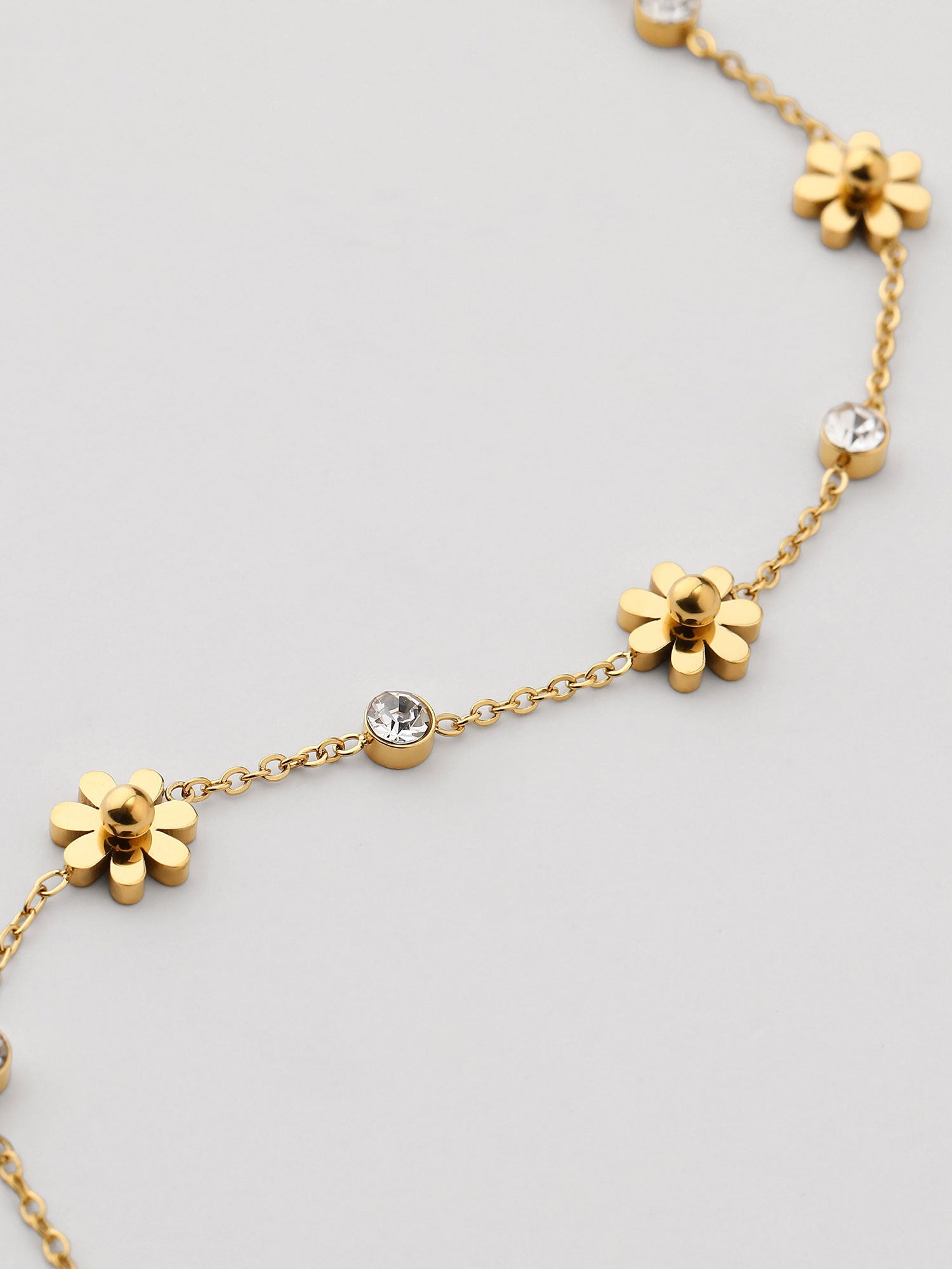 Pulseira de flores com zircónias dorada
